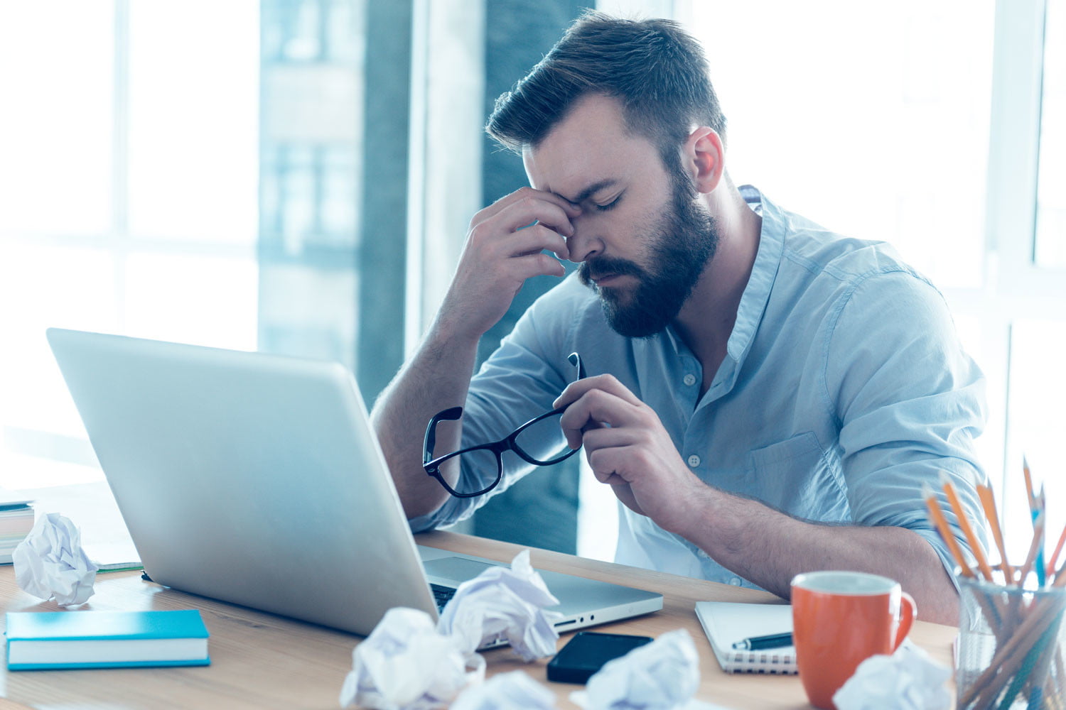 exhausted-man-computer-problems-desk-hacking-hackers-malware-frustration